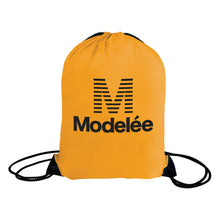 Load image into Gallery viewer, Gold drawstring bag with &#39;Modelée&#39; logo on a white background
